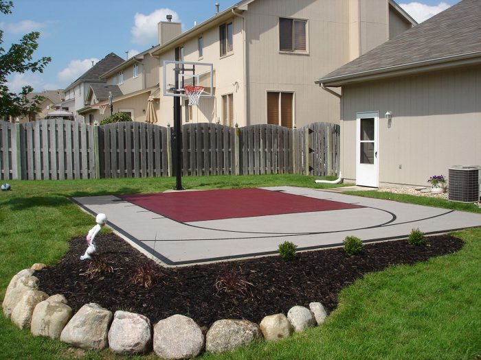 Gray and burgundy backyard basketball court