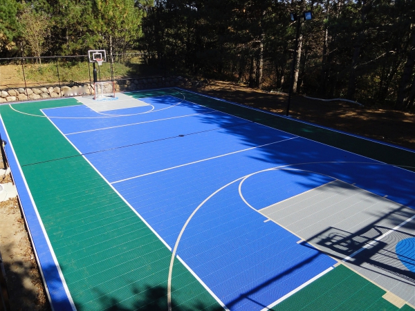 Full multi-court in evergreen, bright blue and gray with hockey lines