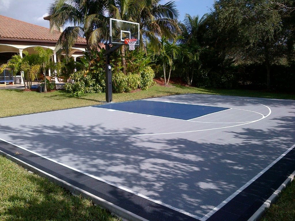 Backyard basketball court with gray and dark blue