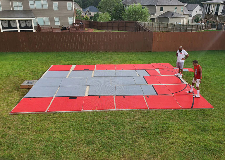 Father and son installing their basketball court