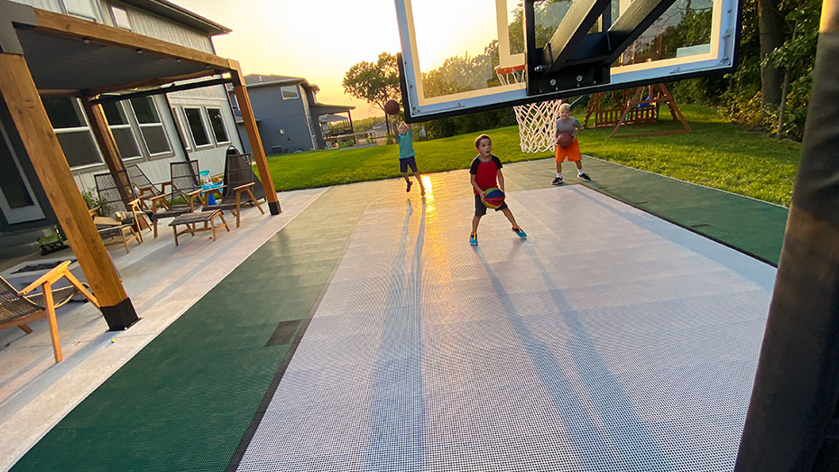 Children playing basketball on a clean court