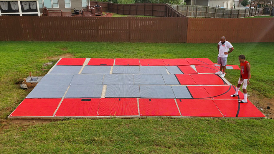 Father and son installing their basketball court