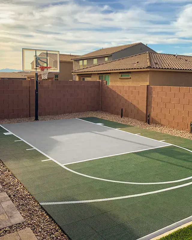 A small green and gray court in a backyard